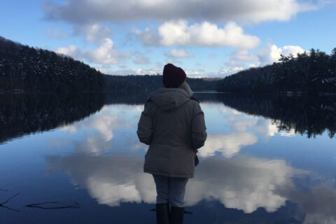 girl standing near lake