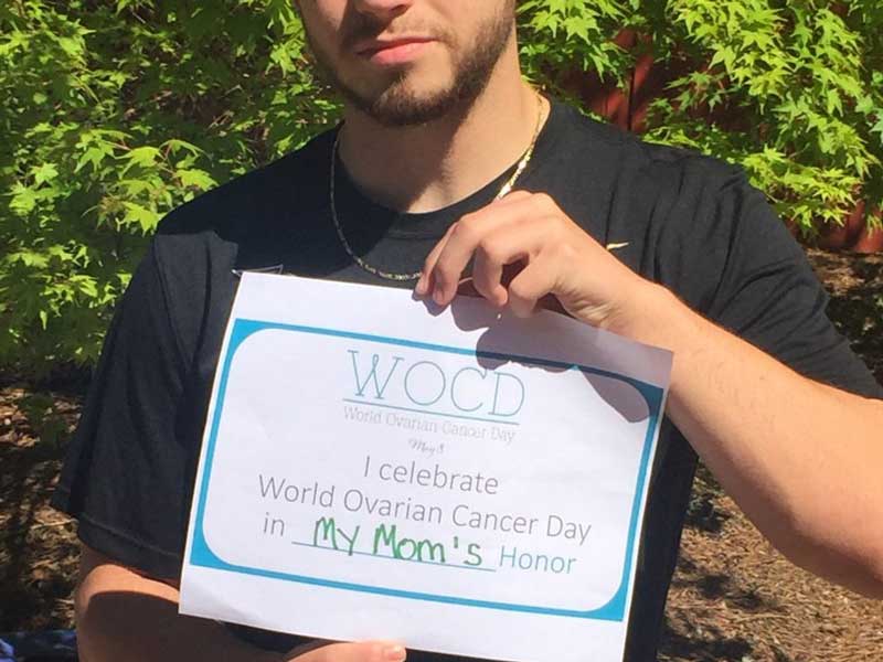 A man holding WOCD banner