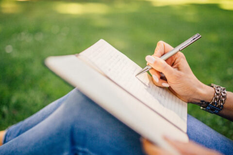 Women writing on book