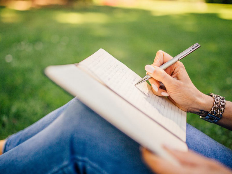 Women writing on book